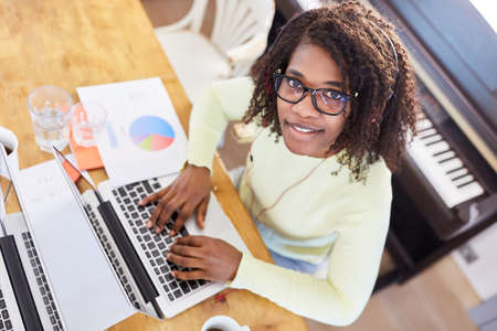Business woman as a freelancer in the home office writes an email on the laptop PC with the touch...