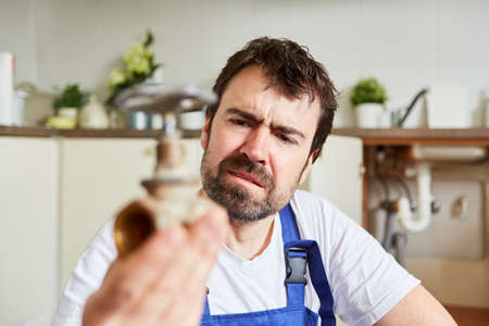 Do-it-yourselfer looks uncertainly at a defective shut-off valve for drain repair