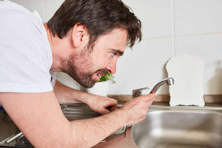 Do-it-yourselfer or professional plumber connecting the kitchen faucetの写真素材