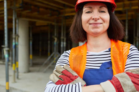 Confident woman as a construction worker with a hard hat as a symbol for equality in the world of...