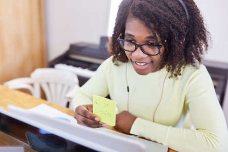 African business woman at the PC making appointments in a video conference in the home officeの写真素材