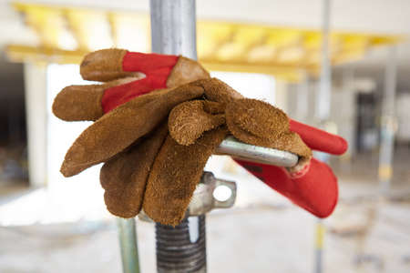 Work gloves on a construction site as a symbol for work clothes and occupational safetyの写真素材