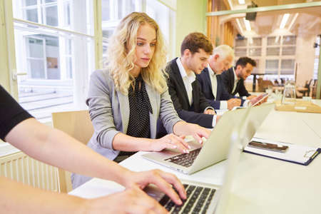 Business people in a business team in a computer training course during e-learningの写真素材