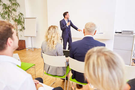 Business man as a speaker at a lecture with presentation in a seminarの写真素材
