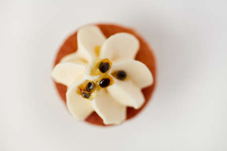 Top view of small sweet cupcake with passion fruit cream and toppingの写真素材