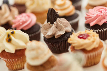 Many small, colorfully decorated cupcakes to celebrate a birthday