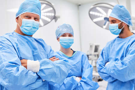 Confident medical team in surgery with protective clothing in the operating room of the clinicの写真素材