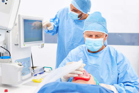 The anesthetist and assistant doctor carefully monitor the patient's anesthesia before the operation