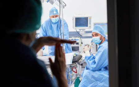 Female doctor gives time-out hand signals to medical team in the intensive care unit for overtime and breakの写真素材