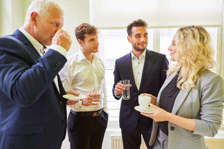 Group of business people on a coffee break having casual small talk