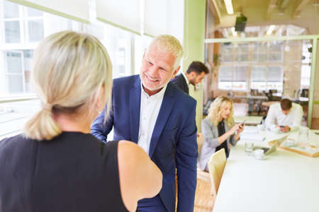 Business people shake hands in greeting or congratulation in the officeの写真素材
