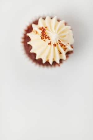 Small cupcake with cream and spices as a topping from aboveの写真素材
