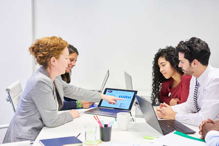 Business start-up team on laptop computer in a financial planning meeting