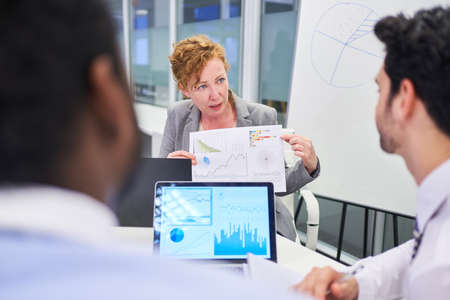 Business woman and colleague analyzing data for financial planning in the office