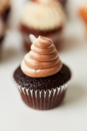 Small sweet chocolate cupcake with vanilla chocolate creamの写真素材