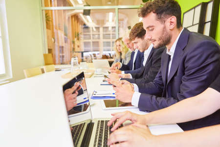 Young business people in computer course or choosing test in assessment centerの写真素材