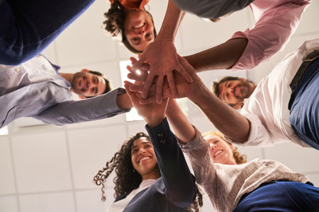Business people stack hands as a symbol of community and togethernessの写真素材