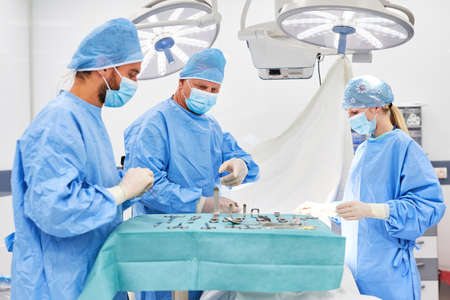 Surgery team with assistant doctor and operating room nurse during an emergency operation in the clinicの写真素材