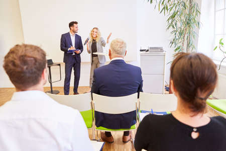 Team of speakers at lecture and presentation at business conference with audience