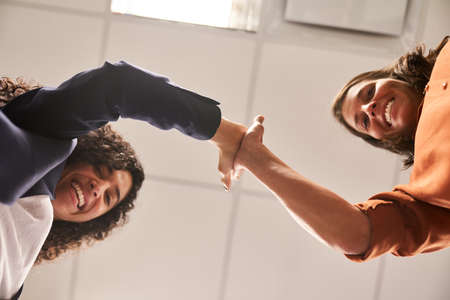Business start-up team people give each other the high five for motivation and team spirit