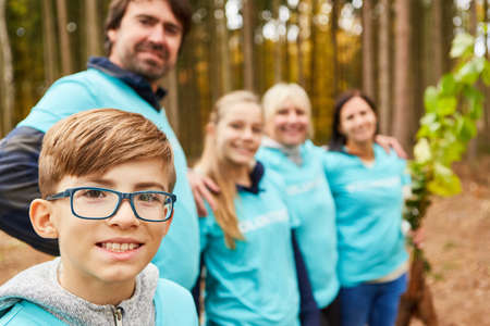 Young and family as environmentalists and volunteers in the forest for sustainable reforestation