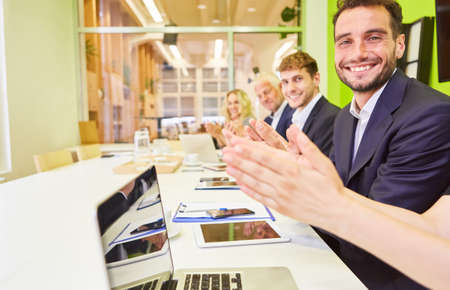 Businesspeople from business team clapping applause in computer class in office