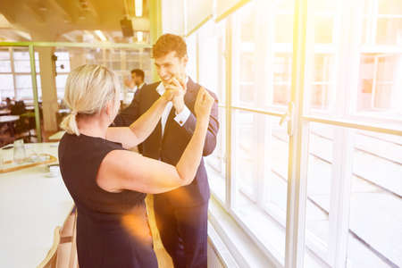 Business people cheering after success together as a team in the officeの写真素材