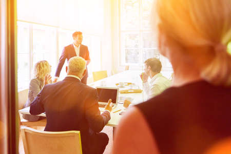 Group of business people talking to each other at business meeting in the officeの写真素材