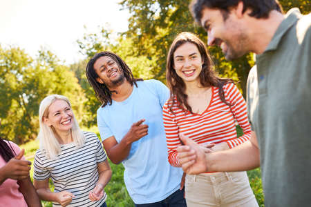 Group of multicultural students making small talk on a nature excursion