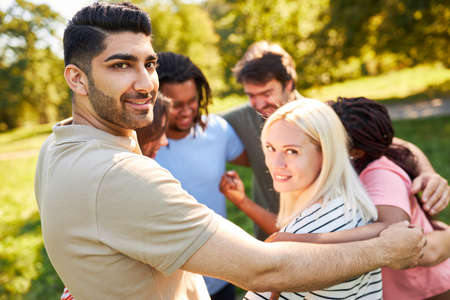 Young people embrace as a community in a circle in the team building workshop