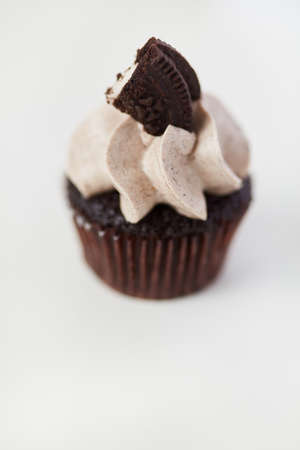 Cookie biscuit cupcake with sweet cream against a white background