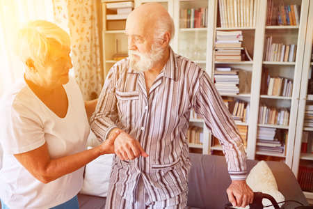 Caregiver helps seniors with dementia with elderly care at home