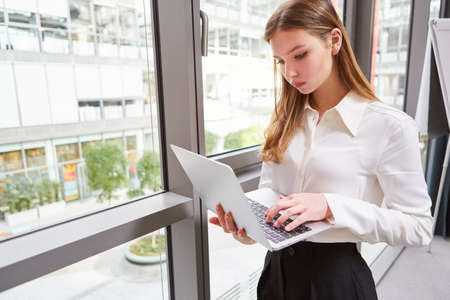 Young business woman in the office is working or researching online on the laptop computer