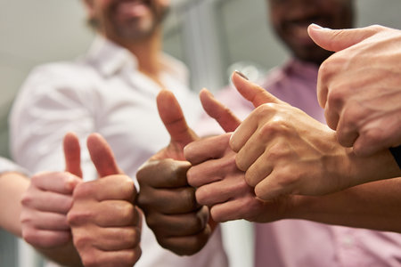 International business team with thumbs up for team spirit and successの写真素材