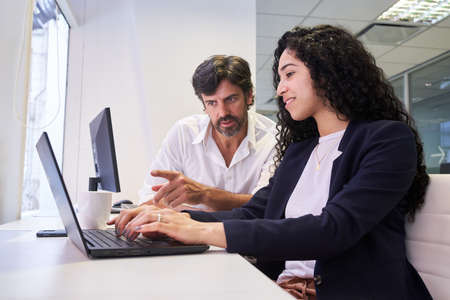 Two business people in a computer workshop or doing an Internet researchの写真素材