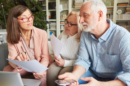 Financial advisor showing senior couple a form or quote for long term care insuranceの写真素材