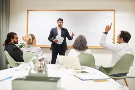Seminar participant asks questions in business workshop on further training in the conference room in the officeの写真素材