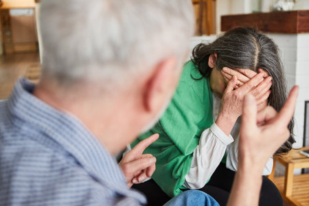 Domestic violence in seniors in care with crying wife and aggressive seniorの写真素材