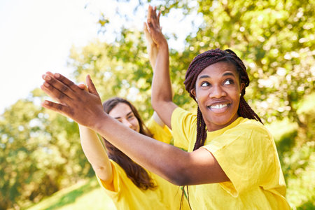 Two women give a high five for motivation at a team building workshopの写真素材