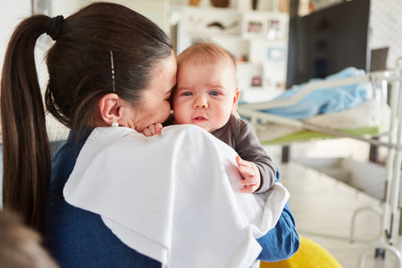 Loving mother holding baby in her arms as a concept of maternal love and motherhood