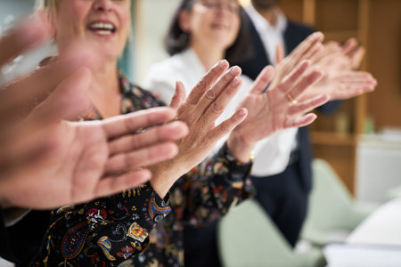 Group of business people clapping and giving applause with hands in office