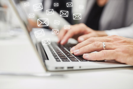 Hands of business woman writing and receiving many emails in the officeの写真素材