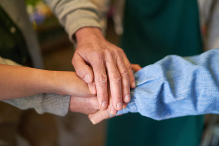 Group of people stacking hands as concept for motivation and team buildingの写真素材