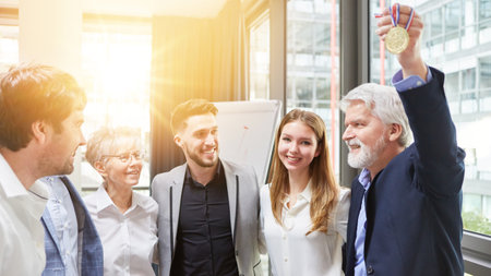 Happy successful business team as winner in competition with medalの写真素材