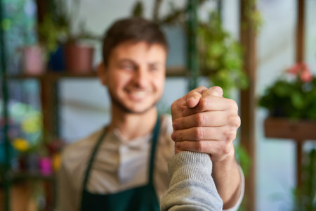 Young florist doing cool handshake as concept for cooperation and congratulationsの写真素材