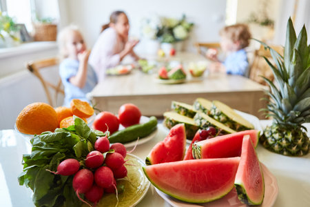 Variety of fresh fruits and vegetables on table at homeの写真素材