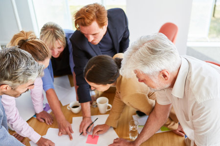 Team of business colleagues discussing documents in meetingの写真素材