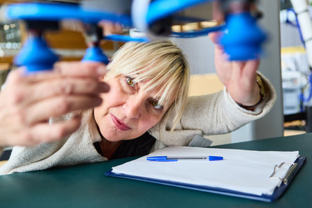 Engineer focuses on inspecting a robot gripper arm, highlighting training in automation and robotics for production, inspection, and industry.の写真素材