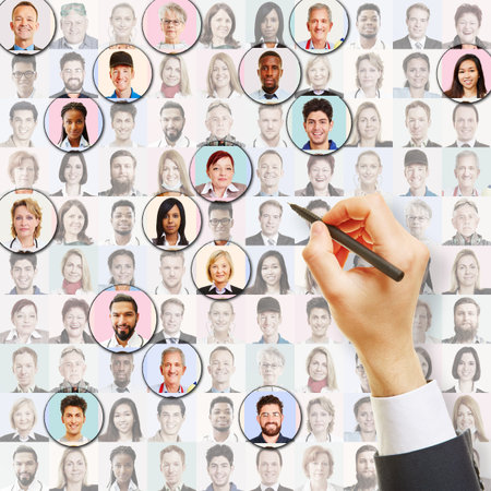 Hand with pen circles portraits of employees as recruitment and placement conceptの写真素材