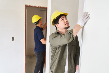 Young carpenters installing doorsの写真素材